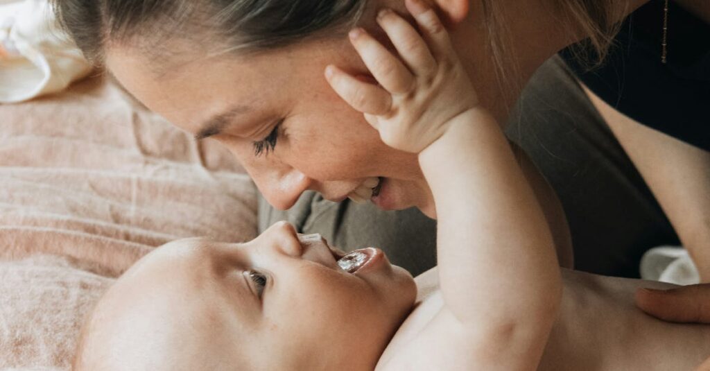 A mother lovingly interacts with her baby, capturing an intimate bonding moment.