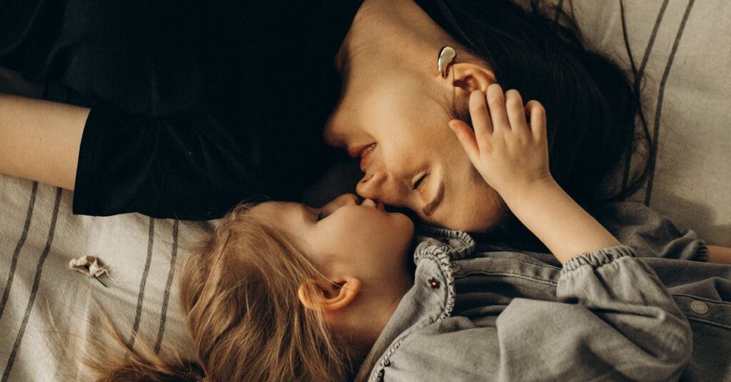 Heartwarming portrait of a mother and daughter lying on a bed, showcasing love and connection.